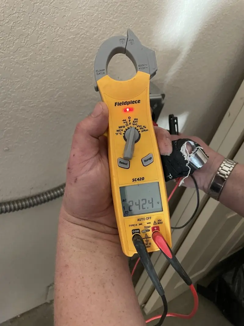 Voltage testing with clamp meter during Outlet Installation in Chicago Ridge